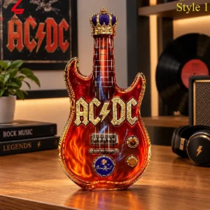 An AC/DC themed electric guitar-shaped glass decanter decorated with flame graphics and a royal crown topper.