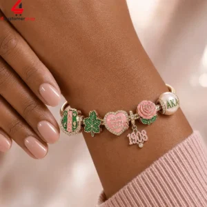 Alpha Kappa Alpha sorority charm bracelet on a wrist