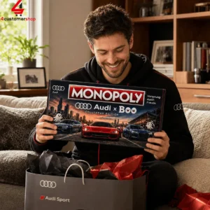 Man smiling while holding an Audi Monopoly collector edition board game.