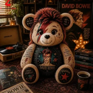 A decorative David Bowie themed plush bear sitting amidst memorabilia.