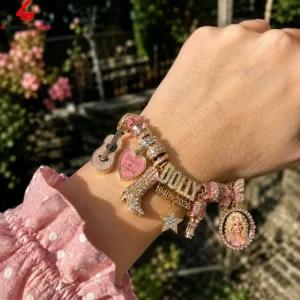 Dolly Parton themed charm bracelet with gold and pink rhinestone accents