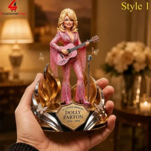 Hand holding a decorative Dolly Parton commemorative figurine