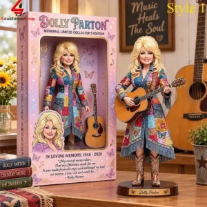 Dolly Parton limited edition commemorative doll with guitar standing next to packaging.