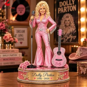 Dolly Parton commemorative collectible figurine in a pink jumpsuit on a decorative base.