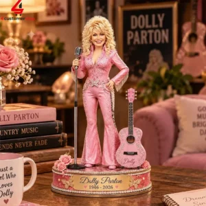 Dolly Parton collectible figurine in a pink sequined jumpsuit with a microphone and guitar on a decorated display base