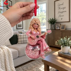 Dolly Parton acrylic holiday ornament hanging on a red ribbon
