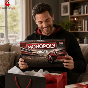 Man smiling while holding a Monopoly Ducati Collector Edition board game box.