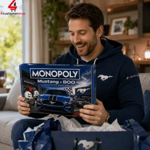 Man smiling while holding a Monopoly Mustang x Boo collector edition board game box.