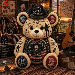 Garth Brooks themed collectible teddy bear wearing a cowboy hat in a rustic room