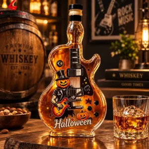 Guitar-shaped glass whiskey bottle with Halloween pumpkin rockstar illustration.