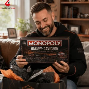 A man smiling while holding a Harley-Davidson collector edition Monopoly board game.