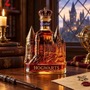 Custom Hogwarts-themed Crown Royal whisky bottle centerpiece on a wooden desk.