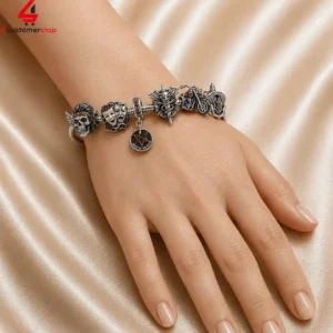 Silver charm bracelet featuring rock and roll themed designs worn on a hand.