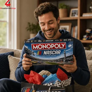 A smiling man holding a NASCAR collector edition Monopoly board game.