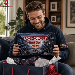 A man smiling while holding a Monopoly Red Bull Racing collector's edition board game box.