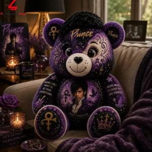 Plush teddy bear tribute to musician Prince sitting on a sofa