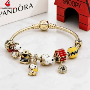 Pandora gold-plated charm bracelet featuring Peanuts Snoopy characters and motifs