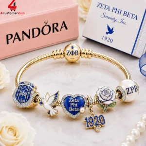 Gold Pandora charm bracelet featuring Zeta Phi Beta sorority symbols, blue heart charm, and dove pendant.